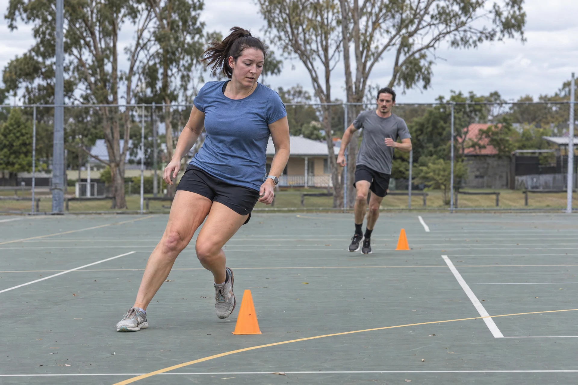 Applicants practising beep-test turns on a Brisbane outdoor sports court