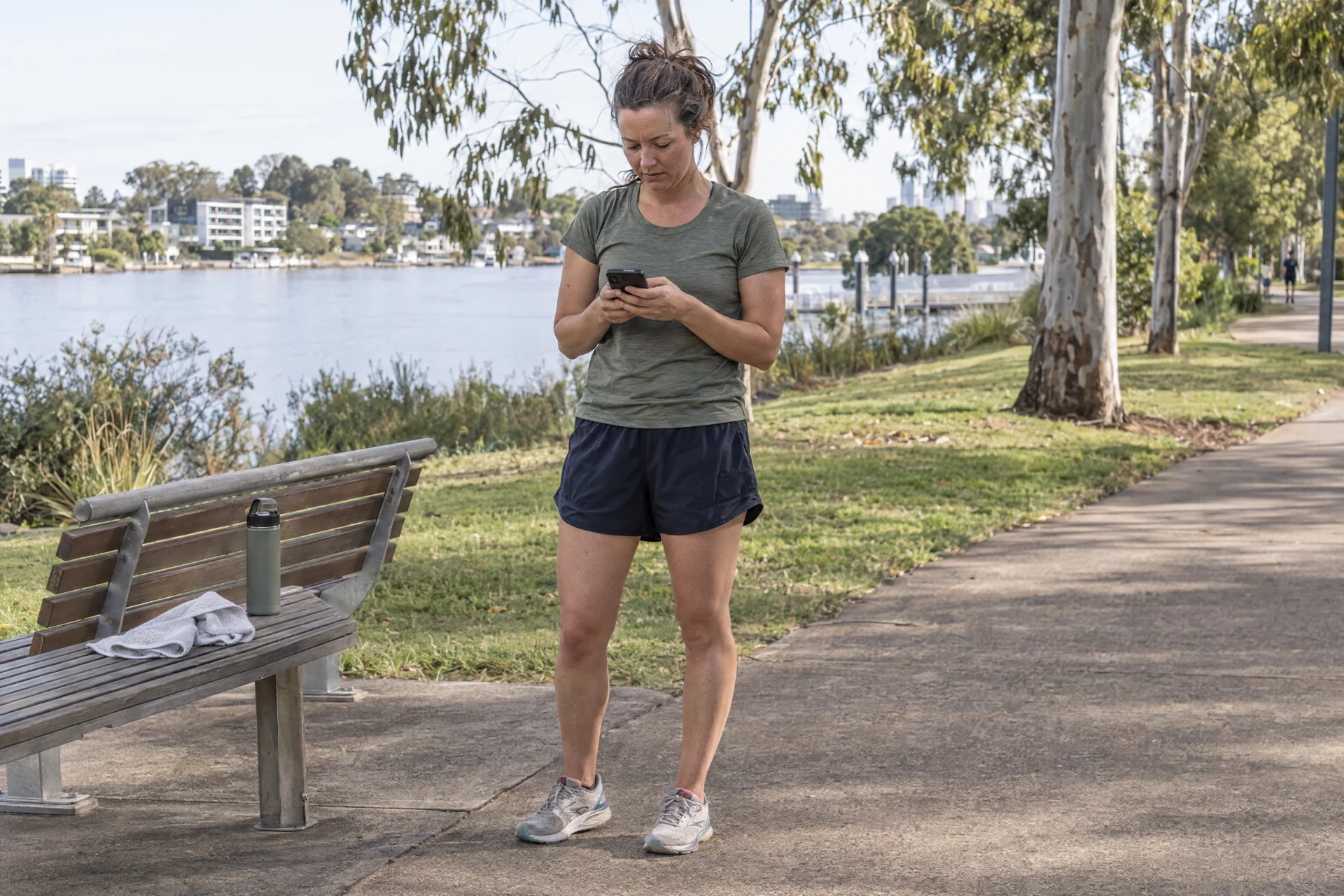 Applicant following a phone-based training program at a Brisbane riverside park